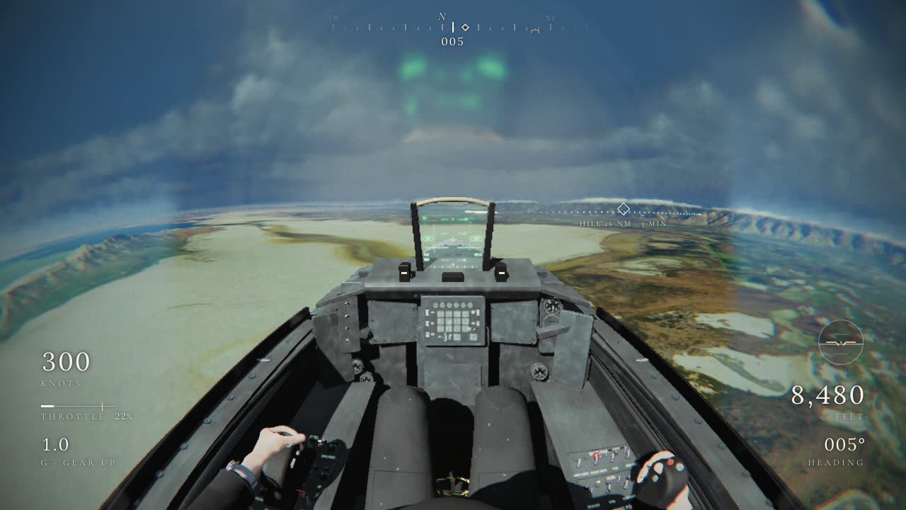 Inbound to Hill at 8,500 ft with every aid on: the compass tape, the steerpoint diamond and its readout, the approach gates, the flight HUD