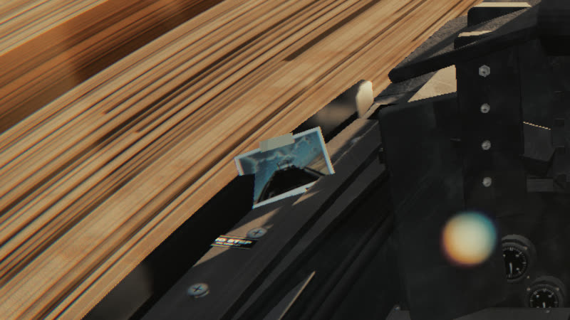 A small print taped to the front of the left canopy sill, catching the low sun